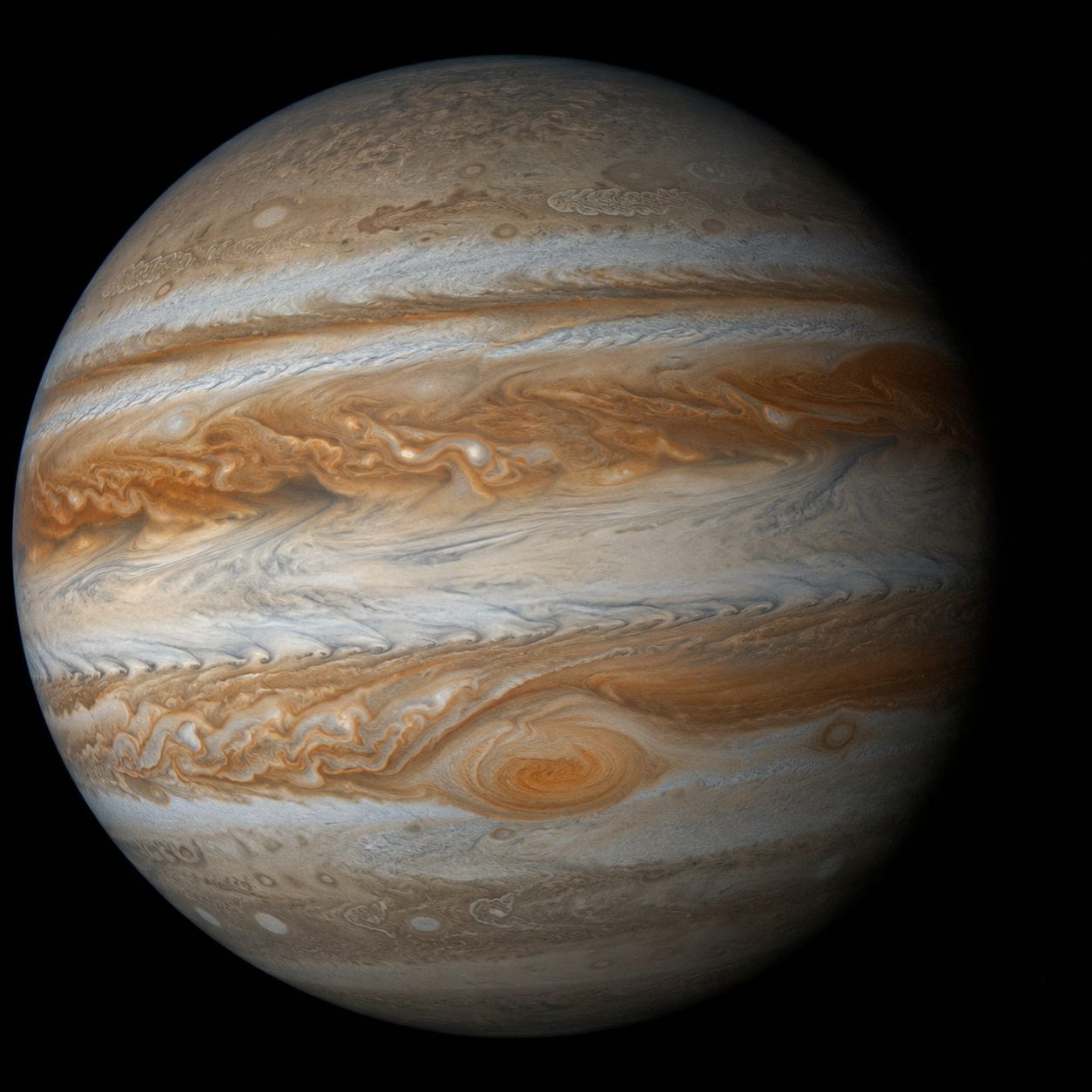 A composite image of Jupiter showing the cream and orange cloud bands and the Great Red Spot in the southern hemisphere.