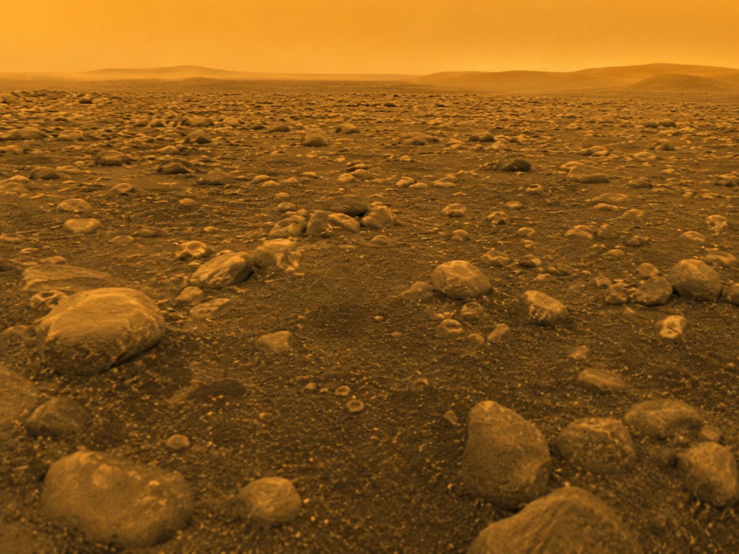 Detailed view of Titan's surface around the Huygens landing site, with pale rounded ice rocks