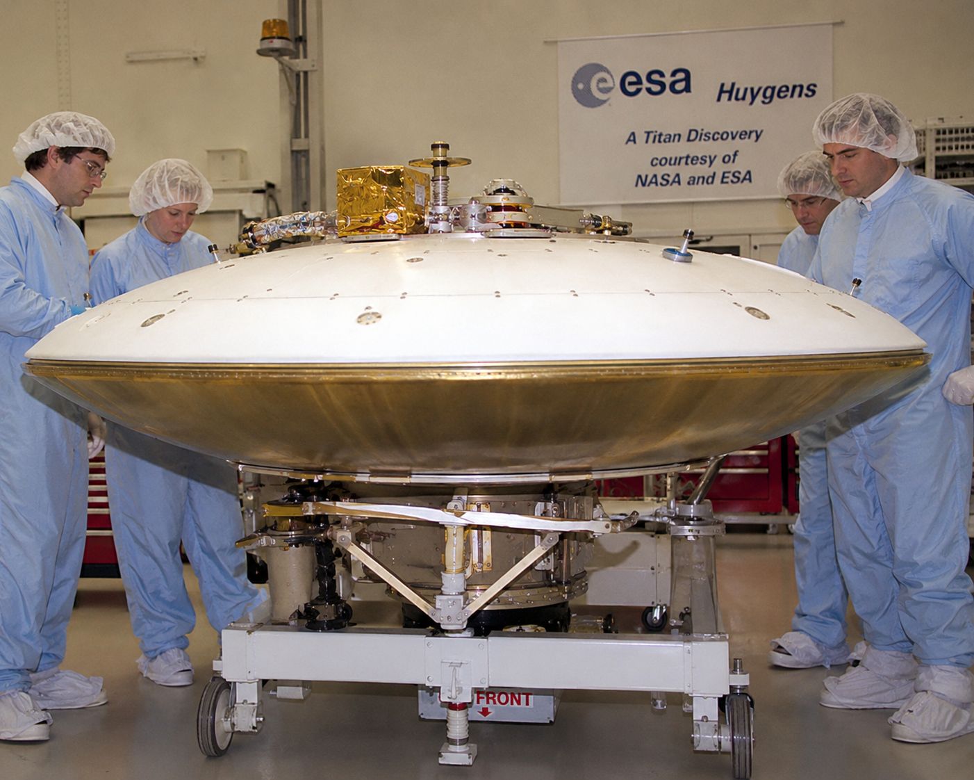 The Huygens probe being prepared at JPL before launch, showing its disc-shaped heat shield