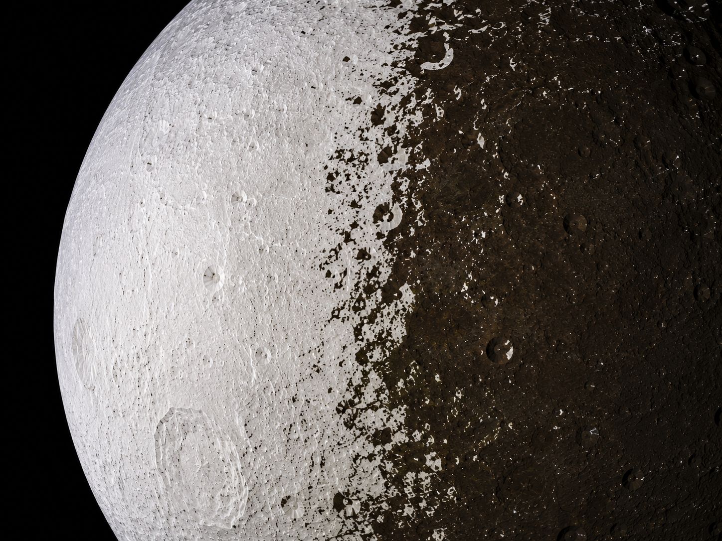 Detailed image of Iapetus showing the sharp boundary between the bright and dark hemispheres