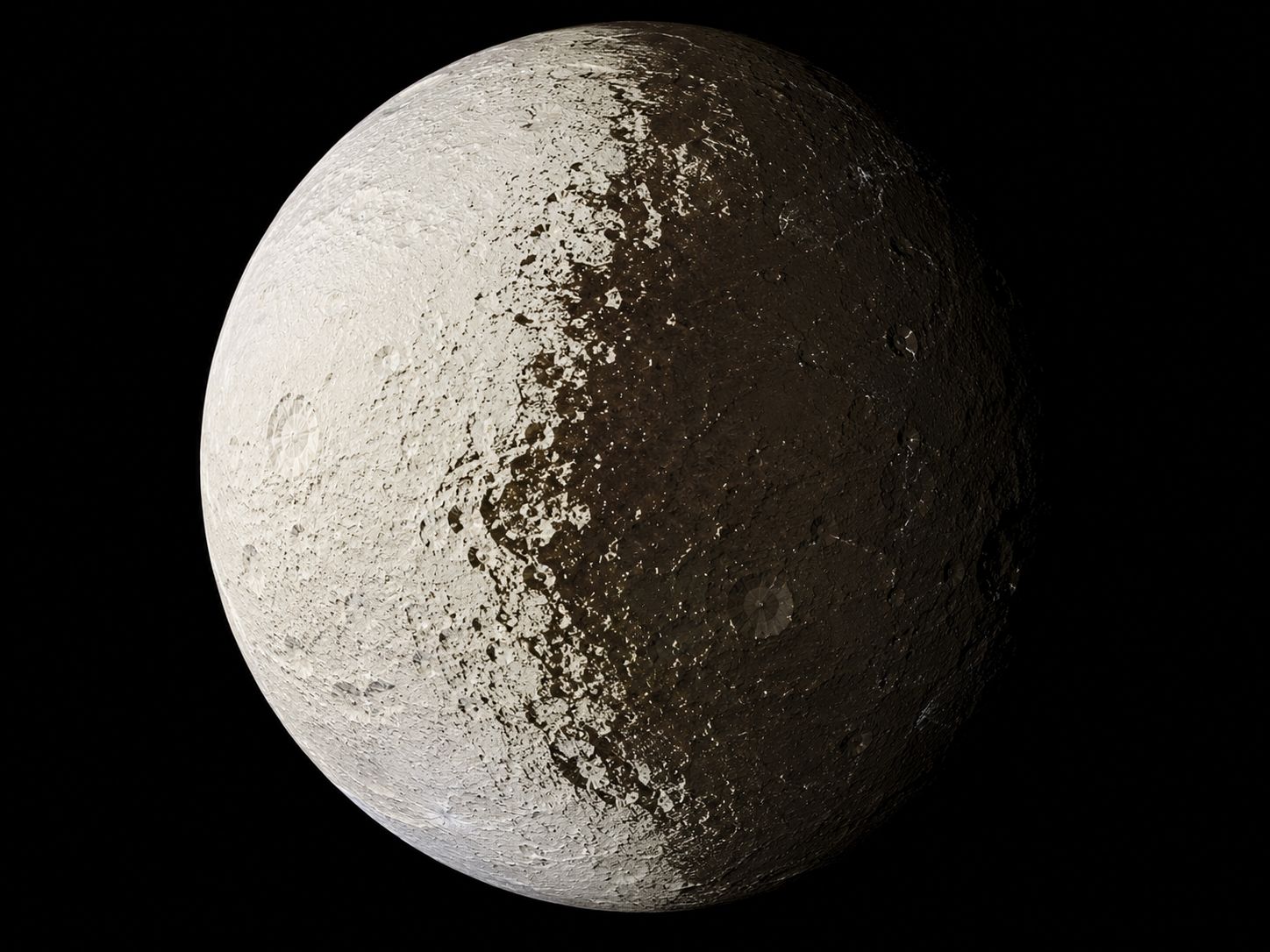 Saturn's moon Iapetus showing its two-tone surface — one hemisphere bright as snow and the other dark as coal