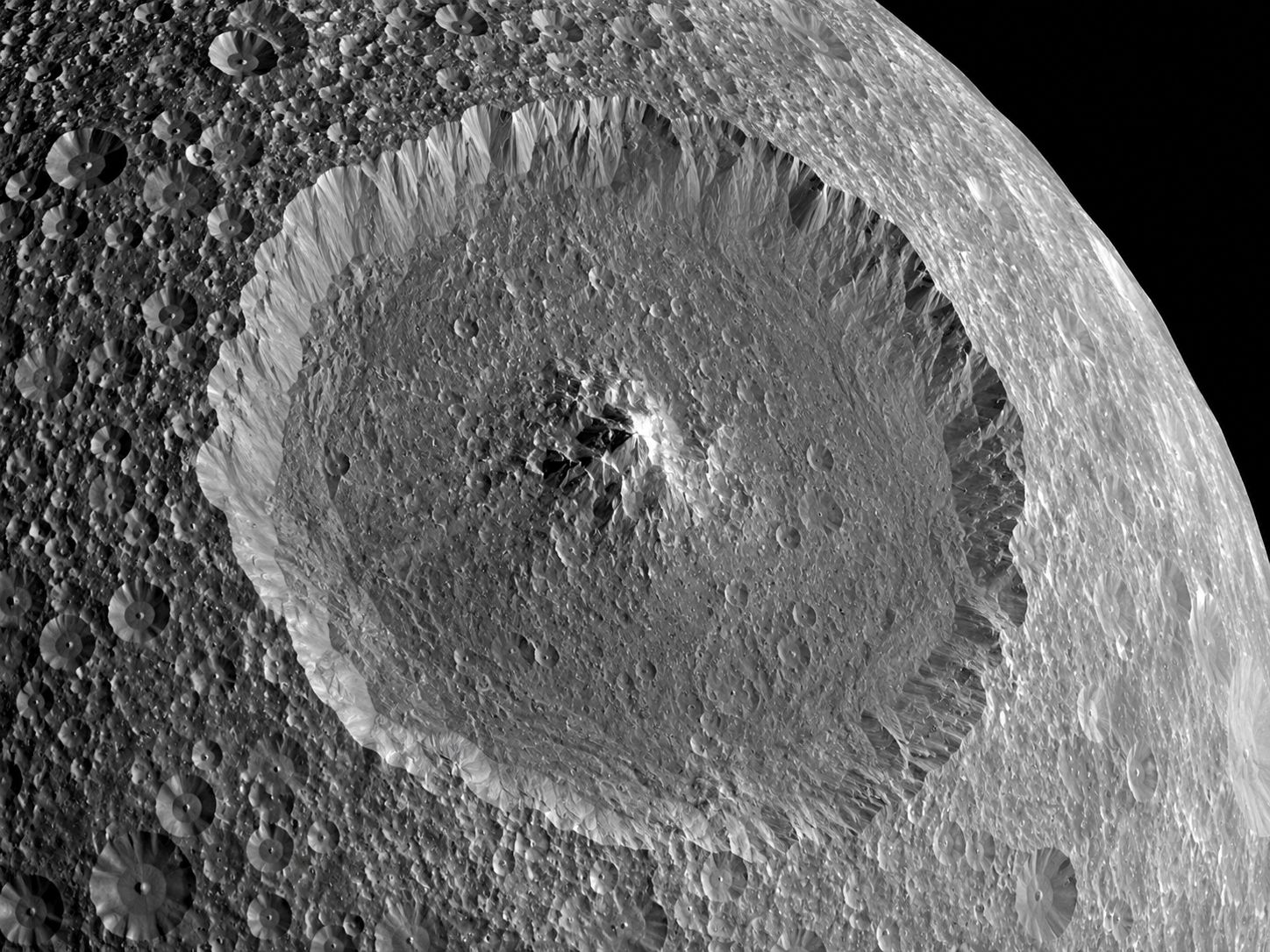 Close-up of Herschel crater on Mimas, showing the central peak rising from the crater floor