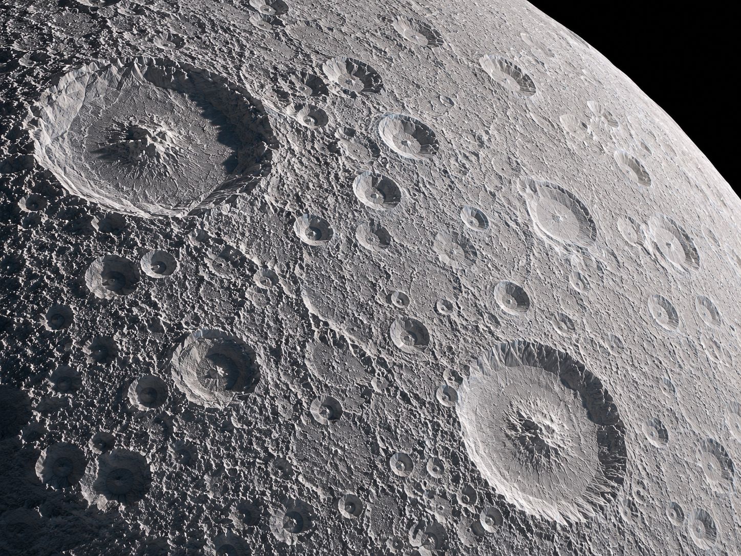 Close-up of Rhea's heavily cratered surface, showing the ancient bombardment that shaped its icy crust