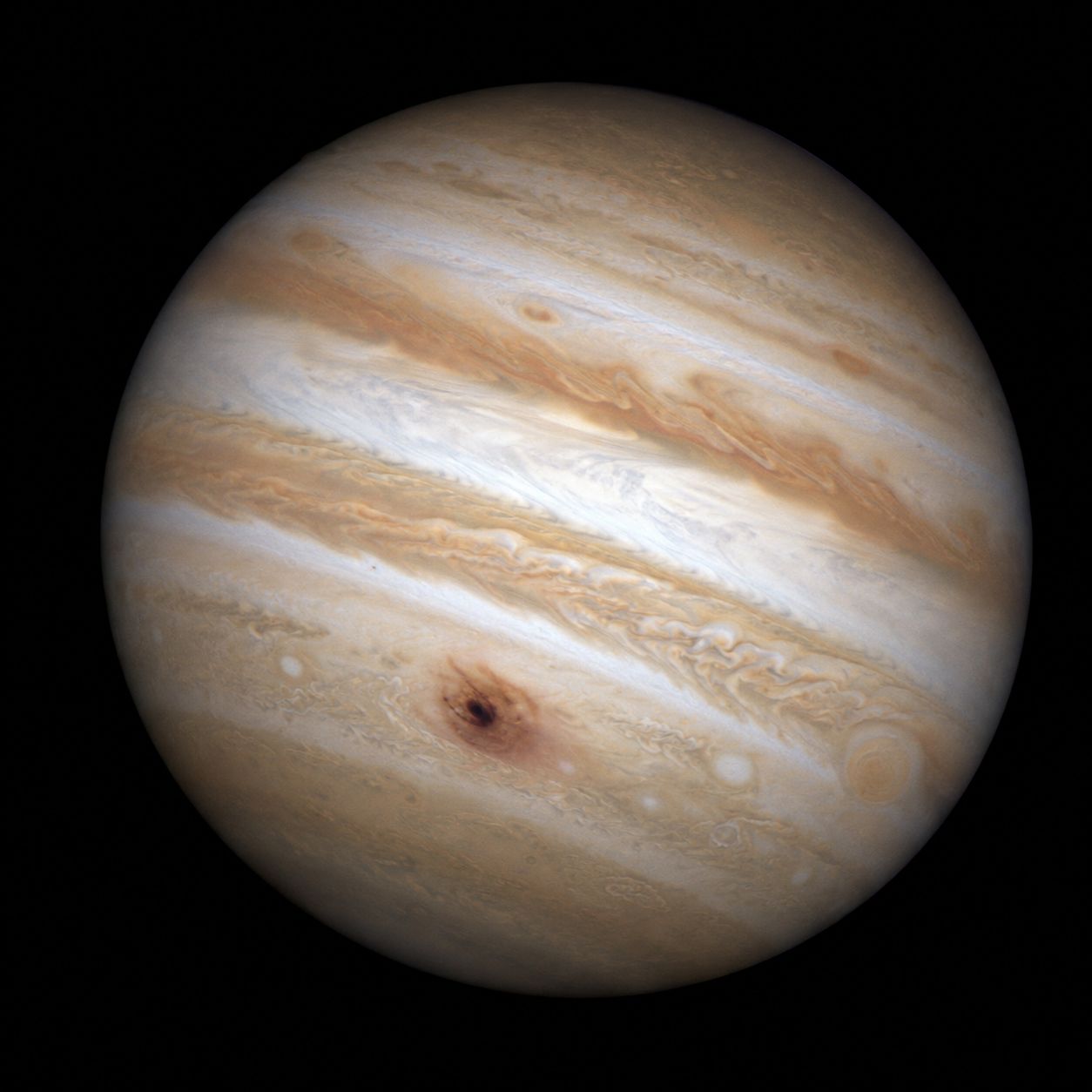 A dark scar in Jupiter’s clouds where a fragment of Comet Shoemaker-Levy 9 impacted in July 1994.